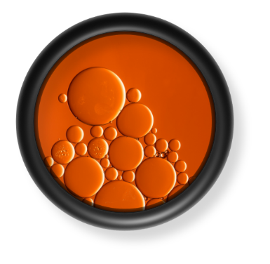 Black O ring with an orange liquid inside of it.